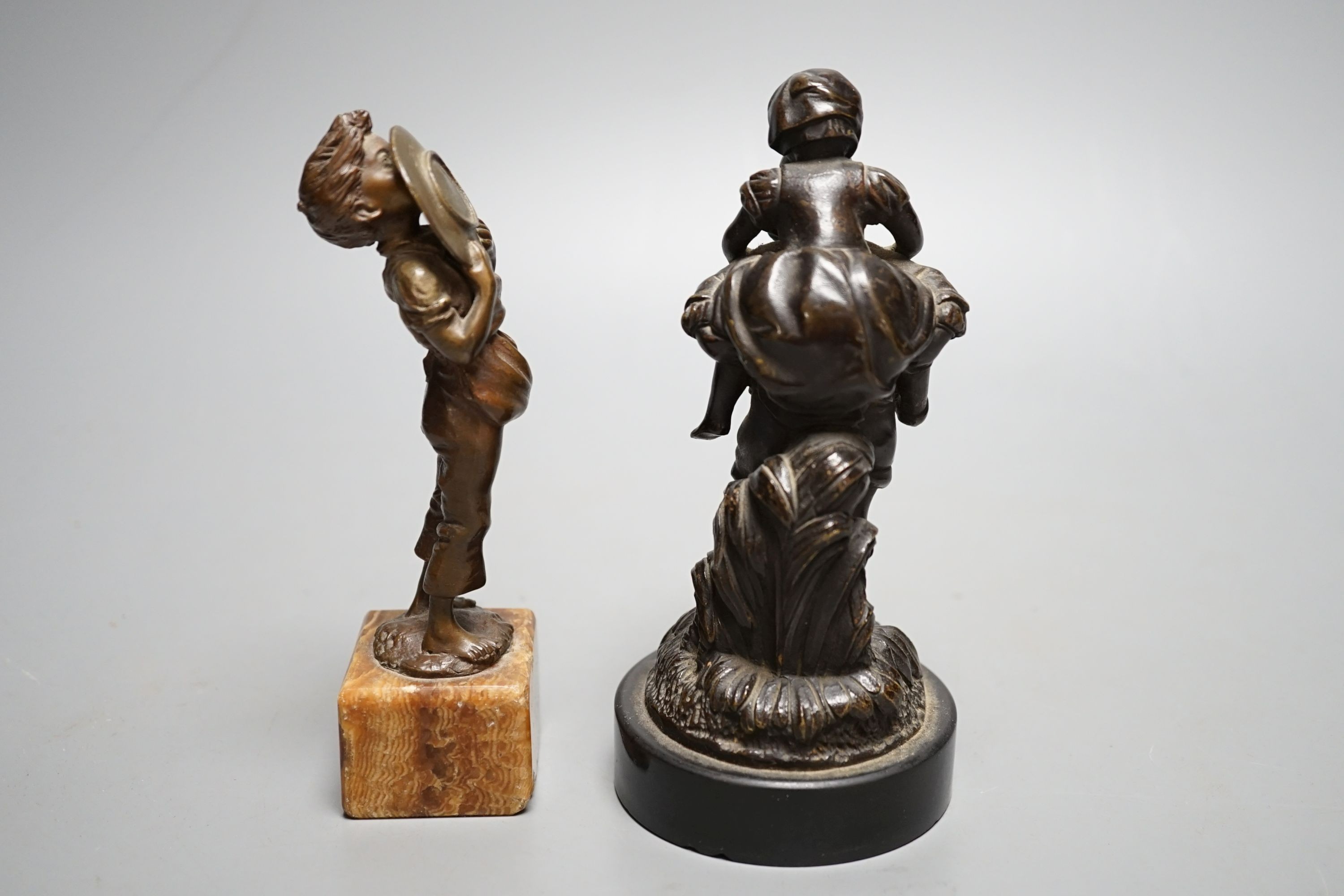 An early 20th century bronze of a boy licking a plate and a Victorian bronze group - tallest 15cm